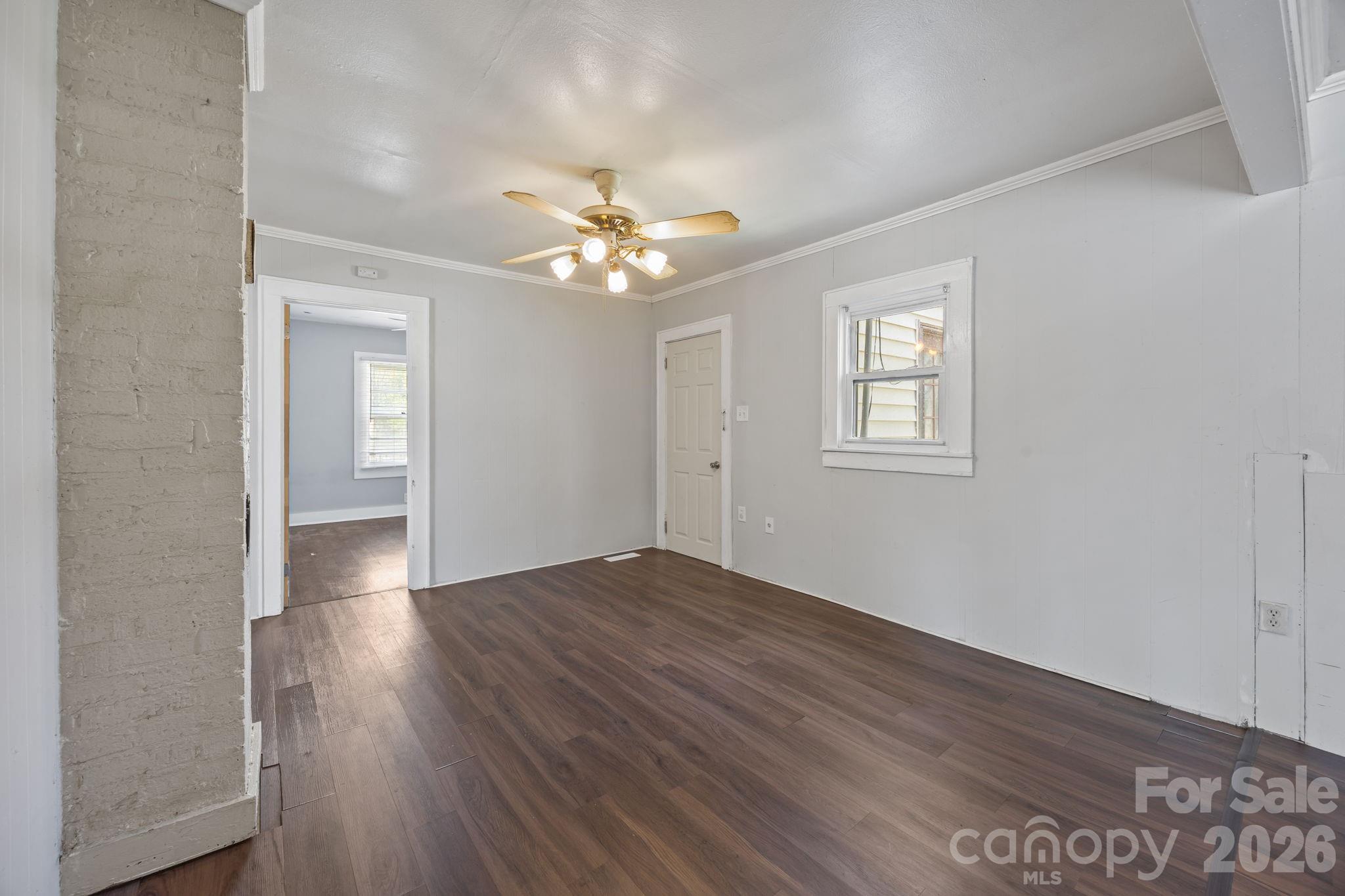 208 Ellis Street Albemarle, NC 28001 - Photo 8 of 38 wooden floor in an empty room with a window