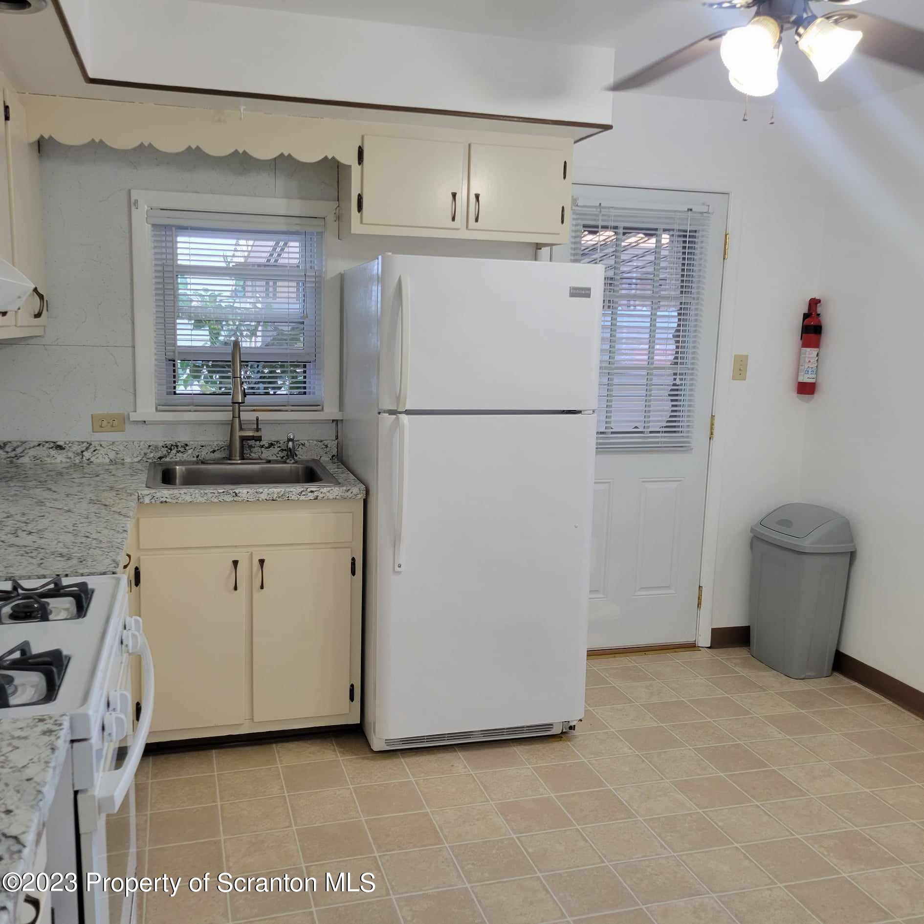648 Prescott Avenue Scranton, PA 18510 - Photo 12 of 25 a utility room with cabinets washer and dryer