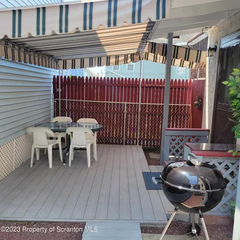 a view of a chairs and table in the patio