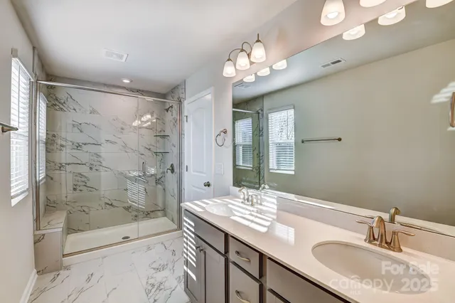 a bathroom with a sink double vanity granite tub and shower