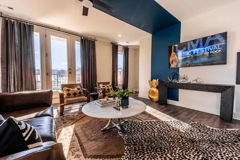 a living room with furniture and large windows