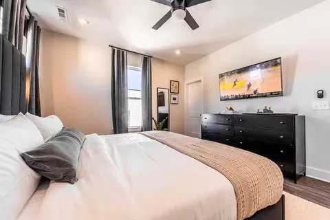 a bedroom with a bed and a flat screen tv