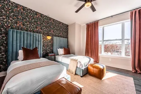 a bedroom with bed and window