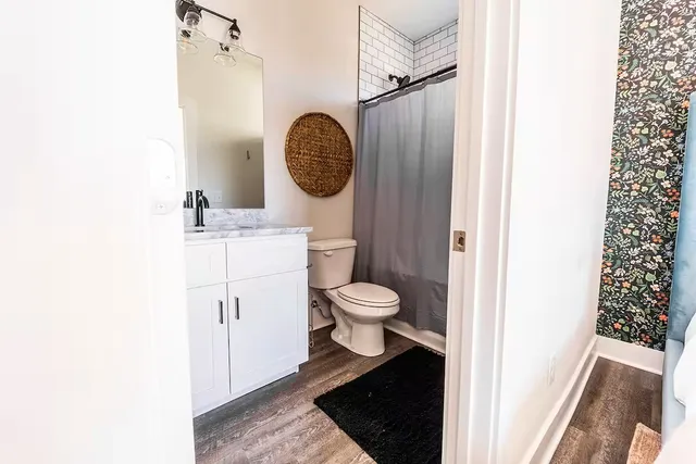 a bathroom with a toilet and a mirror