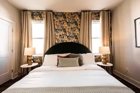 a bedroom with a large bed and a window