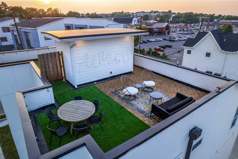 a view of a chairs and table in the back yard