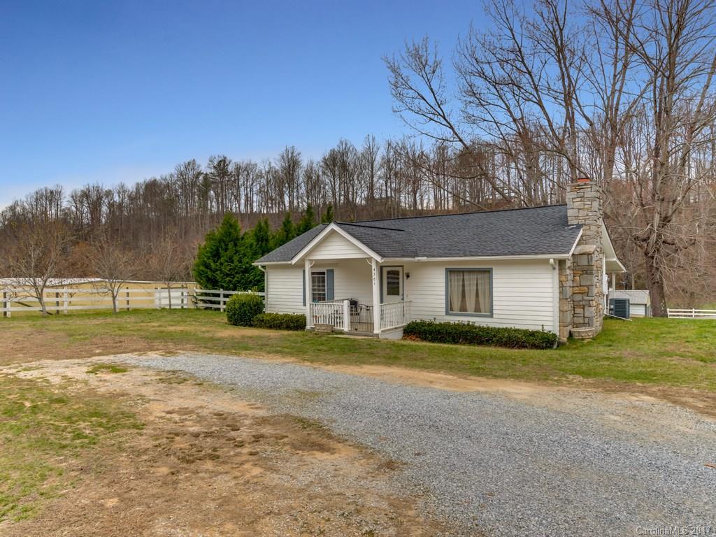 4361 Chimney Rock Road Hendersonville, NC 28792 - Photo 14 of 19 a front view of a house with a yard and trees