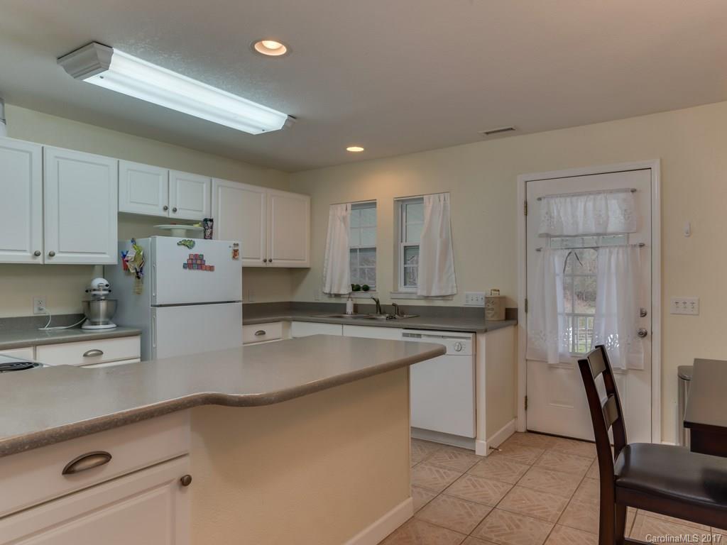 4361 Chimney Rock Road Hendersonville, NC 28792 - Photo 4 of 19 a kitchen with a sink cabinets and window