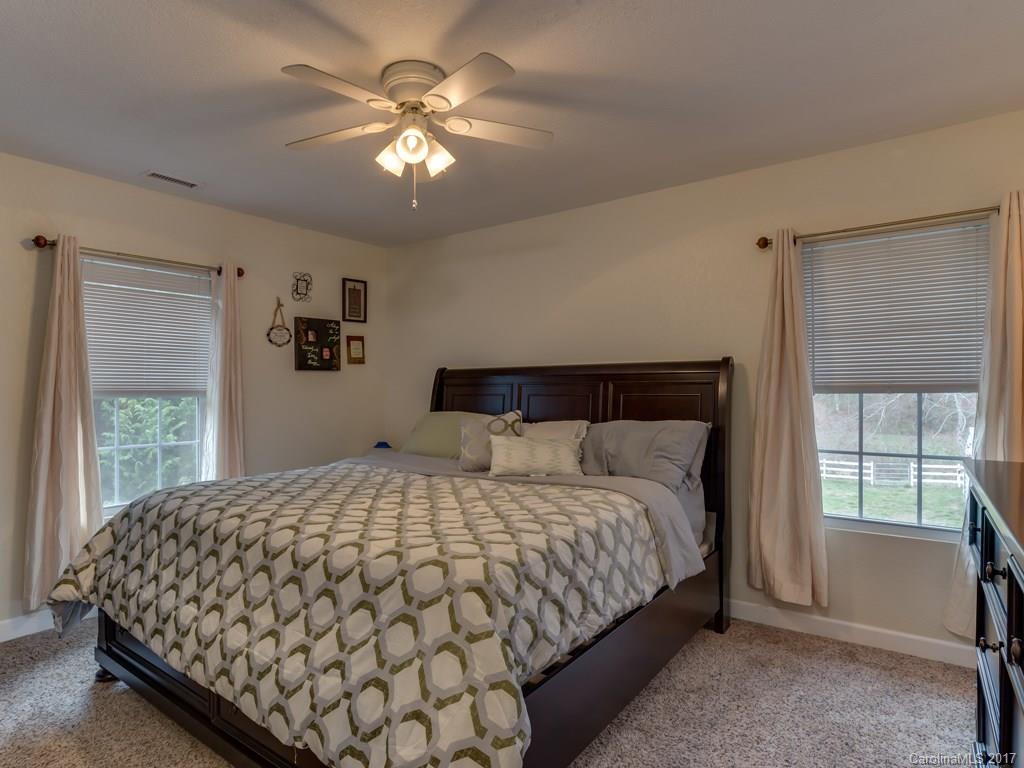 4361 Chimney Rock Road Hendersonville, NC 28792 - Photo 6 of 19 a large bed sitting in a bedroom next to a window