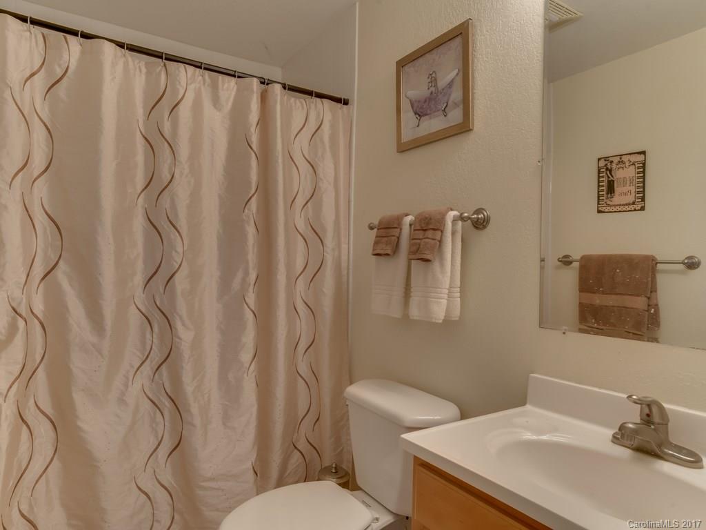 4361 Chimney Rock Road Hendersonville, NC 28792 - Photo 7 of 19 a white toilet sitting next to a bathroom sink