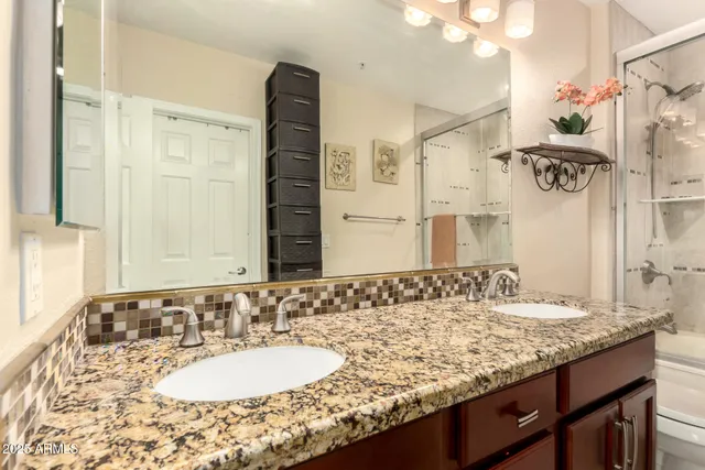 a bathroom with a granite countertop sink and a mirror