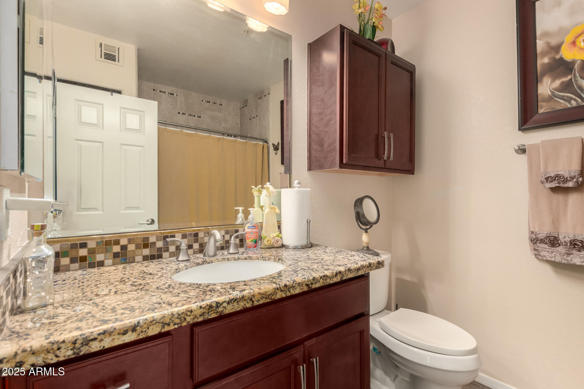 7575 East Indian Bend Road, Unit 2146 Scottsdale, AZ 85250 - Photo 22 of 40 a bathroom with a granite countertop sink toilet and mirror
