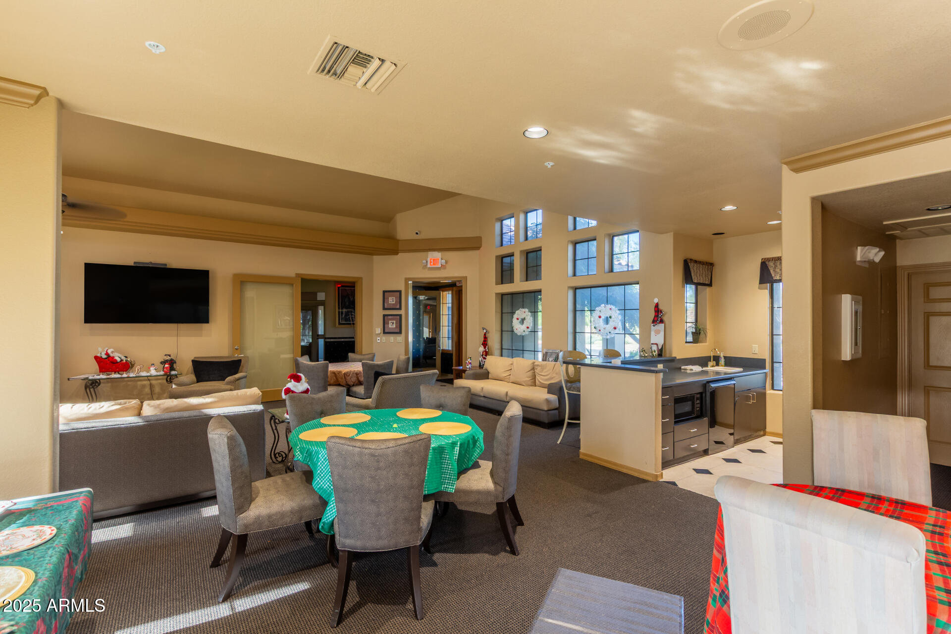 7575 East Indian Bend Road, Unit 2146 Scottsdale, AZ 85250 - Photo 34 of 40 a room with lots of furniture and a flat screen tv