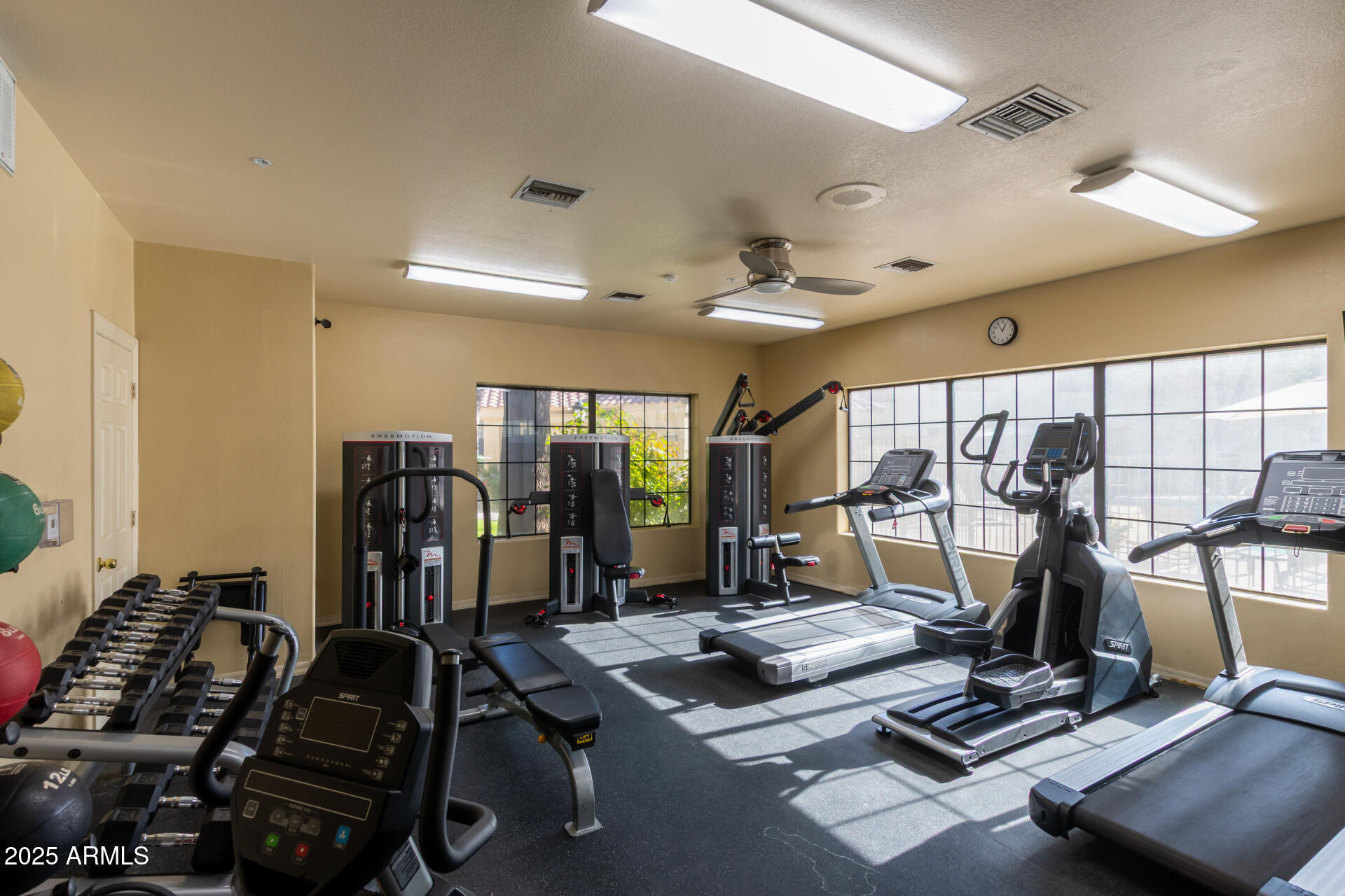 7575 East Indian Bend Road, Unit 2146 Scottsdale, AZ 85250 - Photo 5 of 40 a room with gym equipment and windows