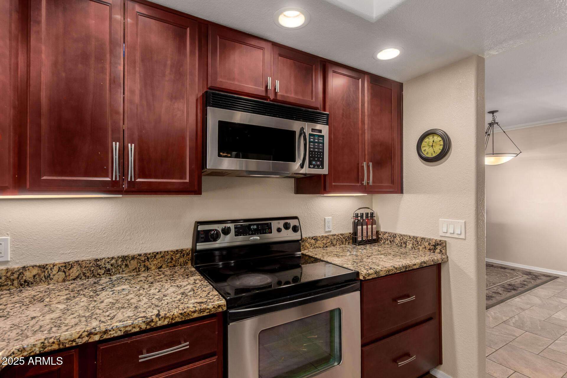 7575 East Indian Bend Road, Unit 2146 Scottsdale, AZ 85250 - Photo 8 of 40 a kitchen with granite countertop stainless steel appliances a stove microwave and sink