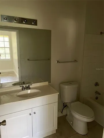 a white toilet sitting next to a bathroom sink