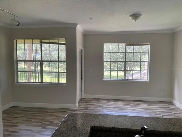 a view of room with wooden floor and window