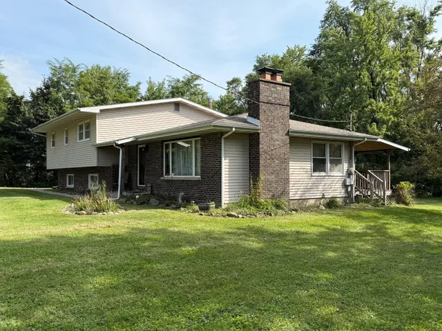a front view of house with yard outdoor seating and green space
