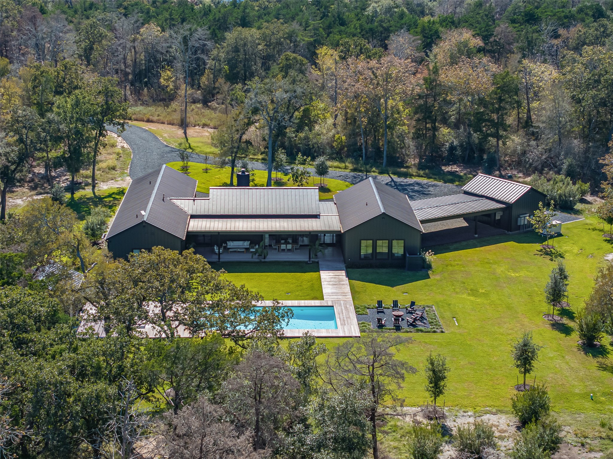 an aerial view of a house with swimming pool patio and lake view