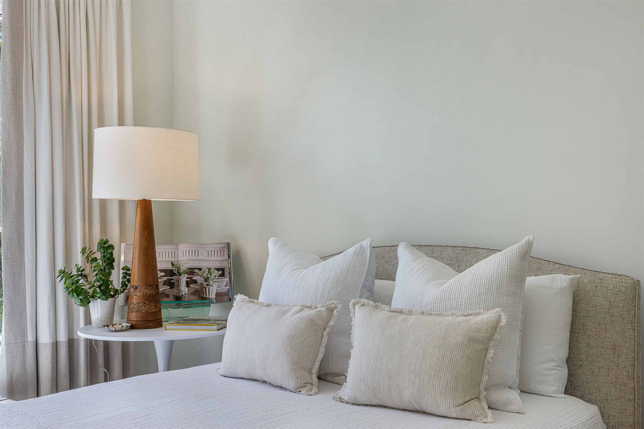 830 South Weyand Road Round Top, TX 78954 - Photo 12 of 35 a bedroom with a bed and a lamp with potted plant