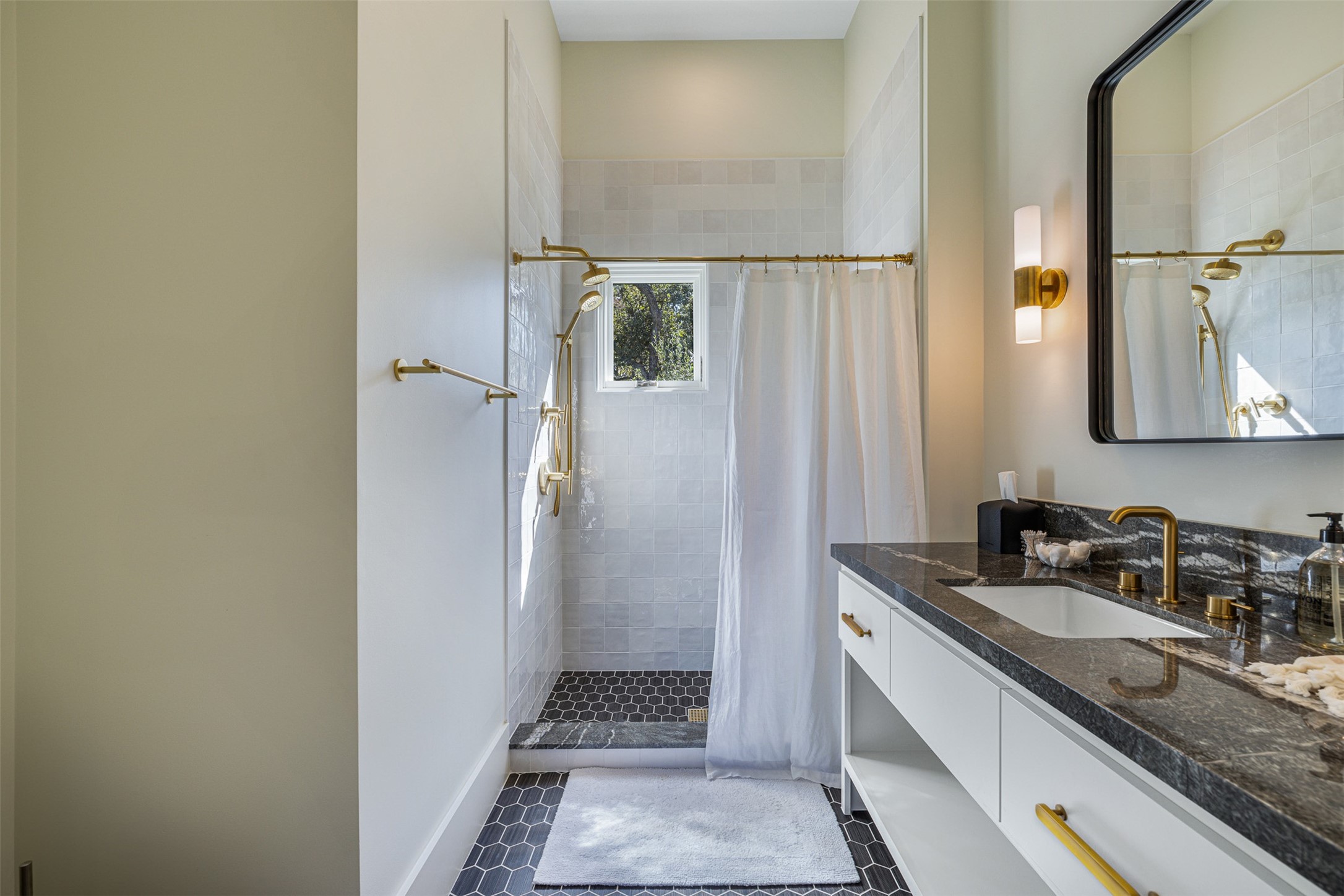 830 South Weyand Road Round Top, TX 78954 - Photo 17 of 35 a bathroom with a granite countertop sink mirror and a shower