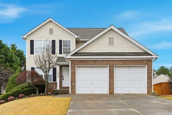 a view of a house with a yard and garage