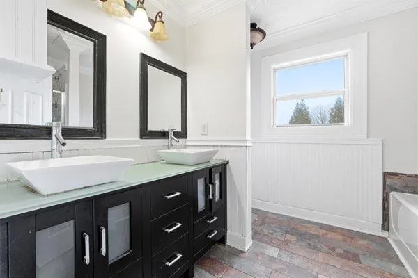 a bathroom with a double vanity sink and a mirror