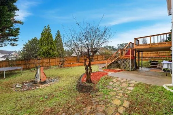 a backyard of a house with childrens swings and slides