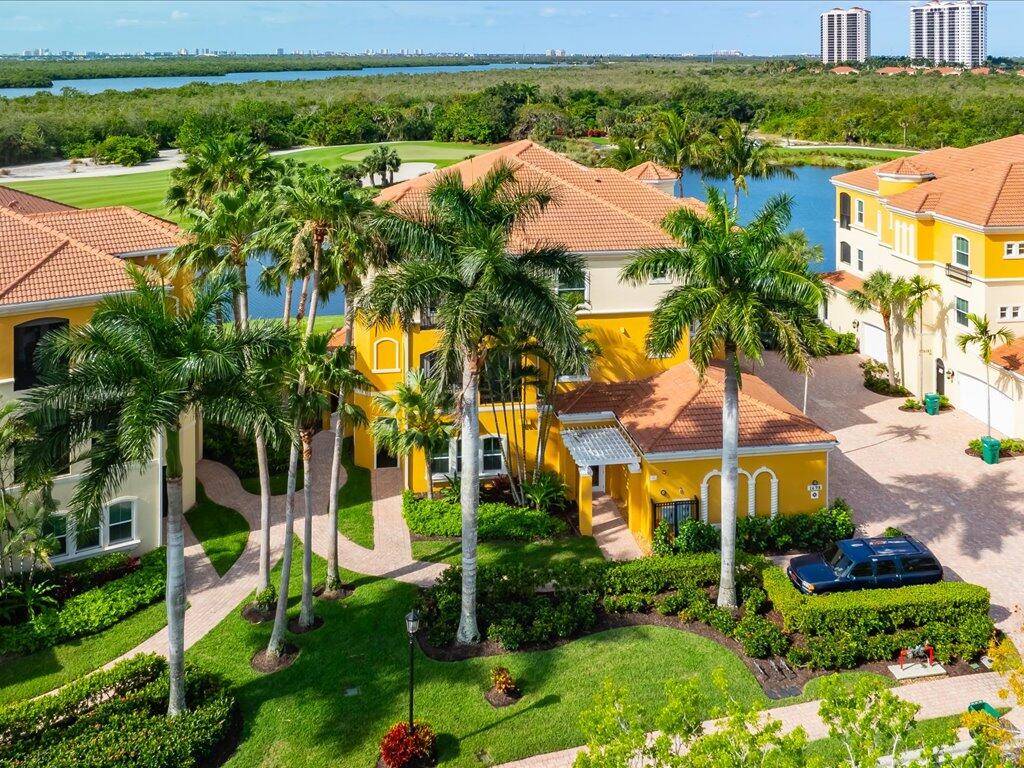 1498 Borghese Lane, Unit 101 Naples, FL 34114 - Photo 1 of 31 a view of a house with a yard and potted plants