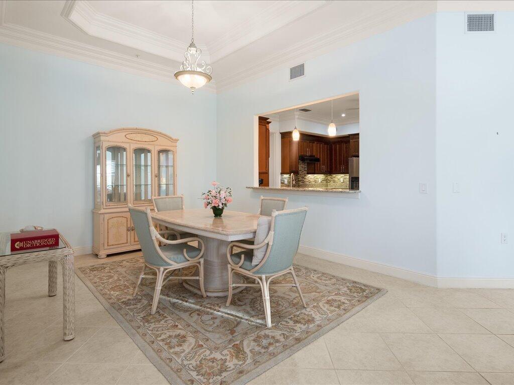 1498 Borghese Lane, Unit 101 Naples, FL 34114 - Photo 13 of 31 a dining room with furniture and window