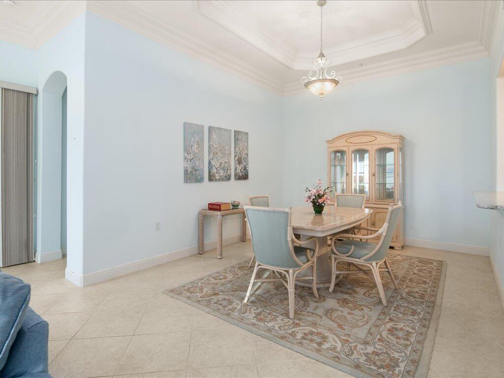 1498 Borghese Lane, Unit 101 Naples, FL 34114 - Photo 14 of 31 a dining room with furniture and window