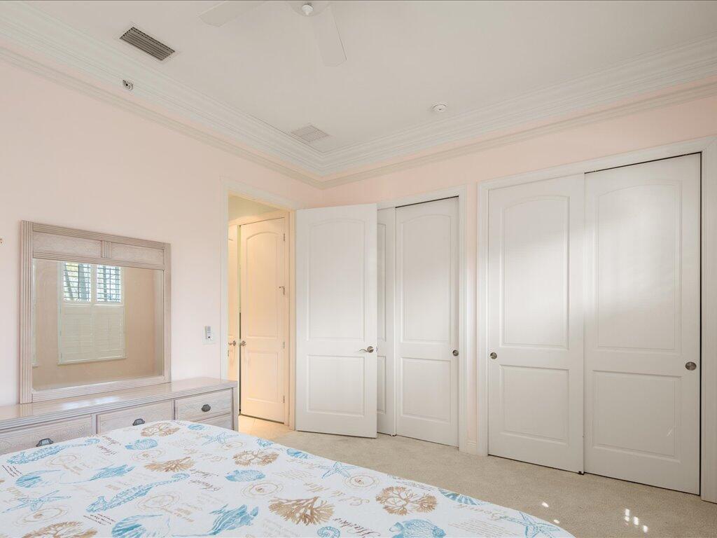 1498 Borghese Lane, Unit 101 Naples, FL 34114 - Photo 18 of 31 a view of a bedroom with a bedroom and windows