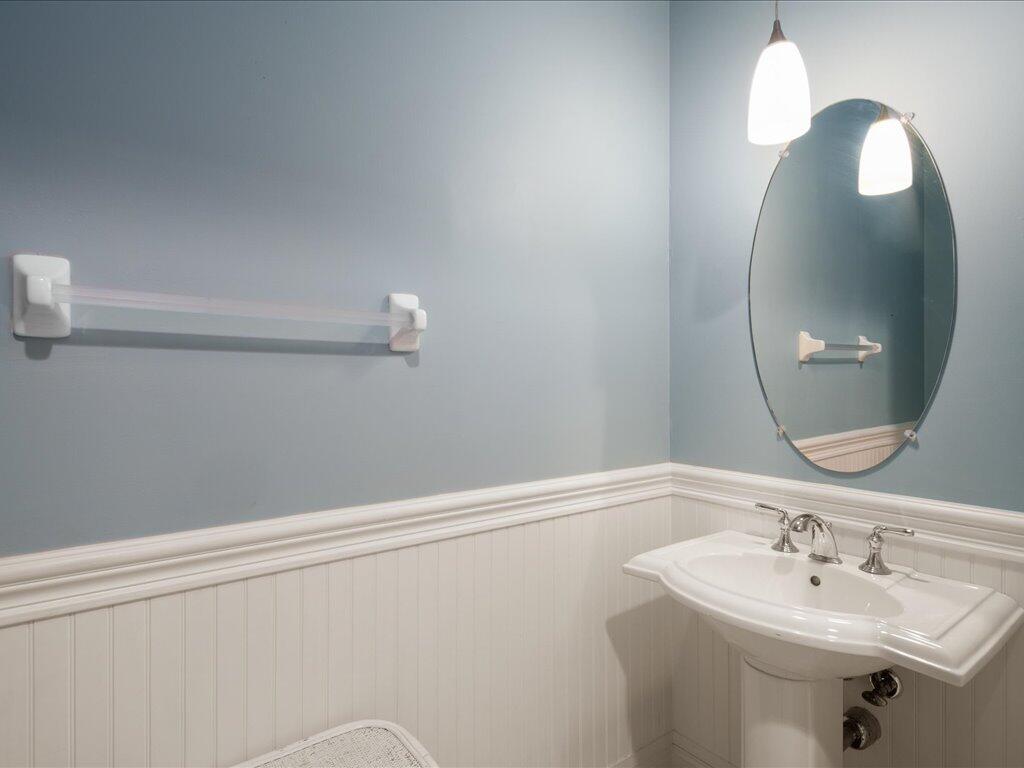 1498 Borghese Lane, Unit 101 Naples, FL 34114 - Photo 20 of 31 a bathroom with a sink a vanity and a mirror