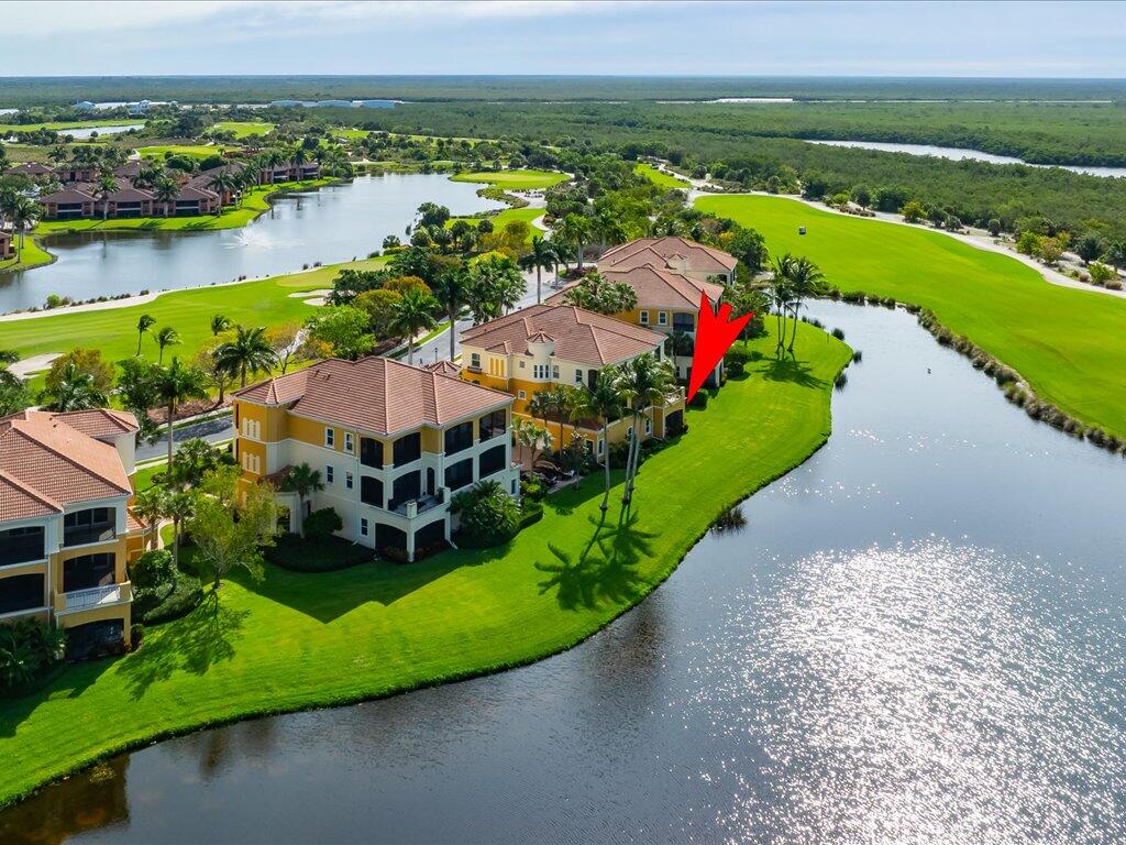 1498 Borghese Lane, Unit 101 Naples, FL 34114 - Photo 2 of 31 an aerial view of a house with a lake view