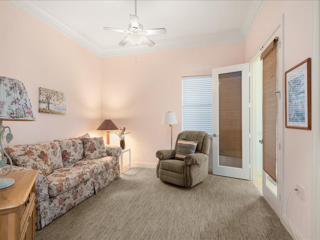 1498 Borghese Lane, Unit 101 Naples, FL 34114 - Photo 22 of 31 a living room with furniture and a chandelier