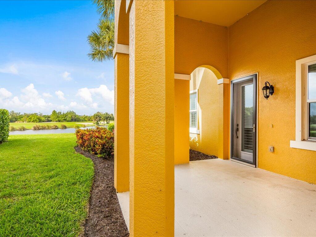 1498 Borghese Lane, Unit 101 Naples, FL 34114 - Photo 25 of 31 a view of a swimming pool with an outdoor space and seating area