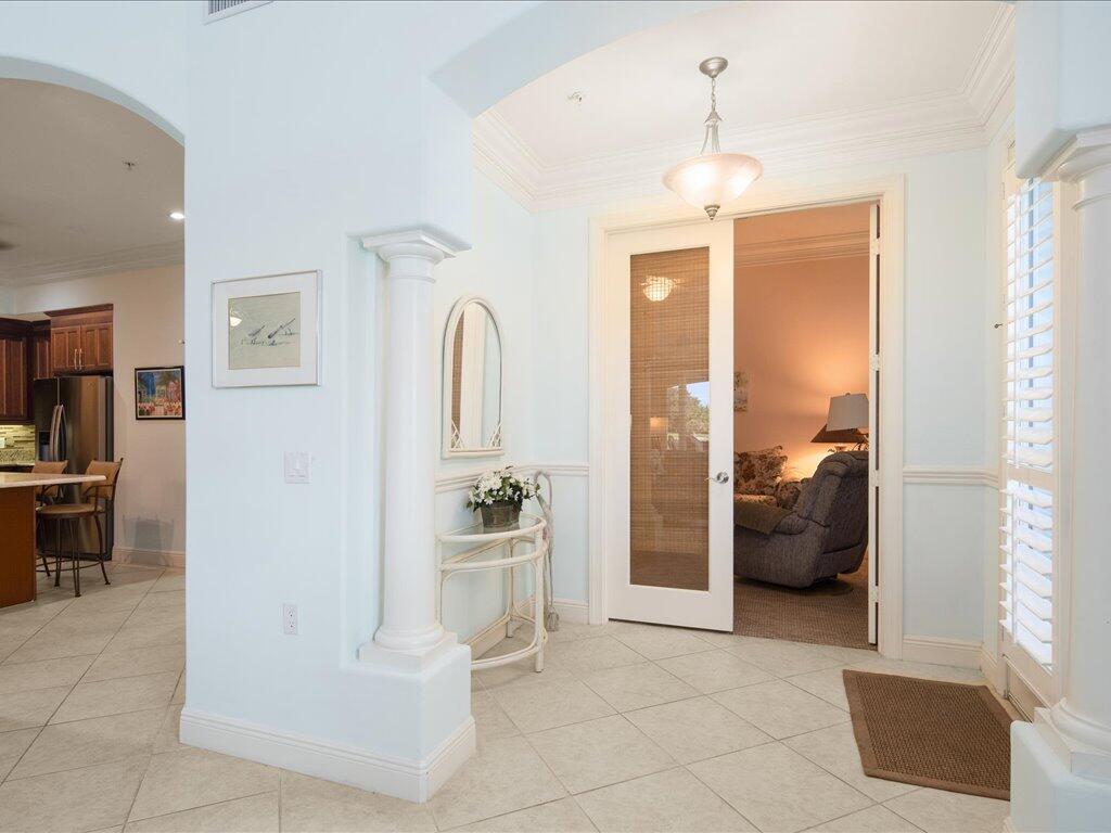 1498 Borghese Lane, Unit 101 Naples, FL 34114 - Photo 6 of 31 a view of a livingroom with furniture and front door