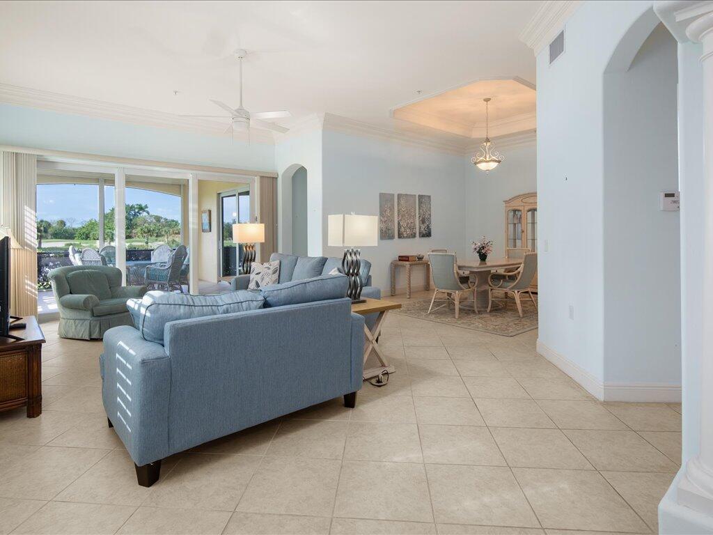 1498 Borghese Lane, Unit 101 Naples, FL 34114 - Photo 8 of 31 a living room with furniture and a dining table