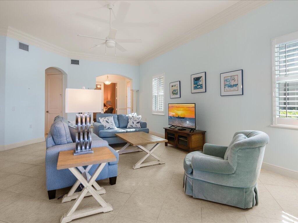1498 Borghese Lane, Unit 101 Naples, FL 34114 - Photo 9 of 31 a living room with furniture and a flat screen tv
