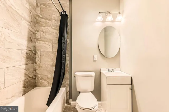 a bathroom with a toilet and a mirror