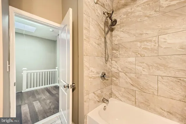 a bathroom with a bathtub and shower