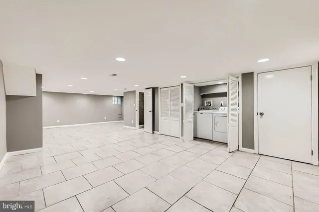 a view of a kitchen with a sink and a refrigerator