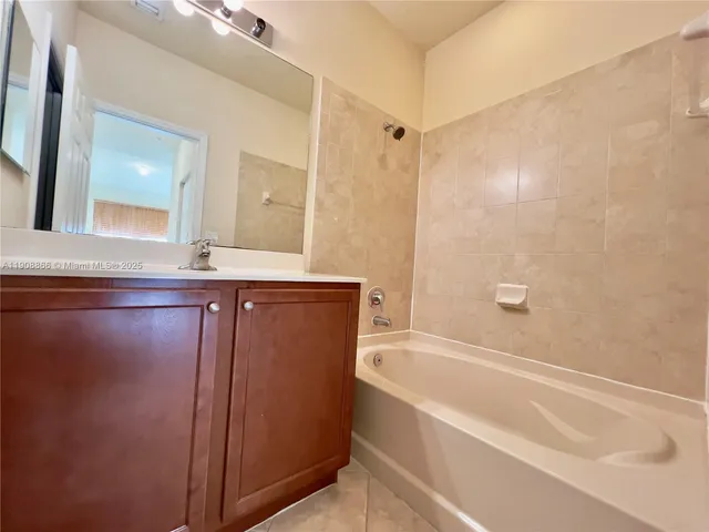 a bathroom with a bathtub and a sink