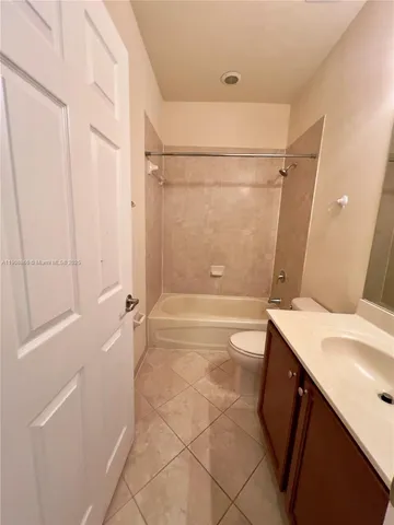 a bathroom with a sink a toilet a mirror and shower