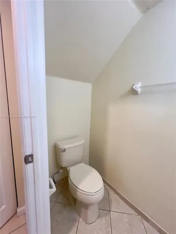 a white toilet sitting next to a shower