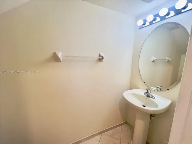 a bathroom with a sink and mirror