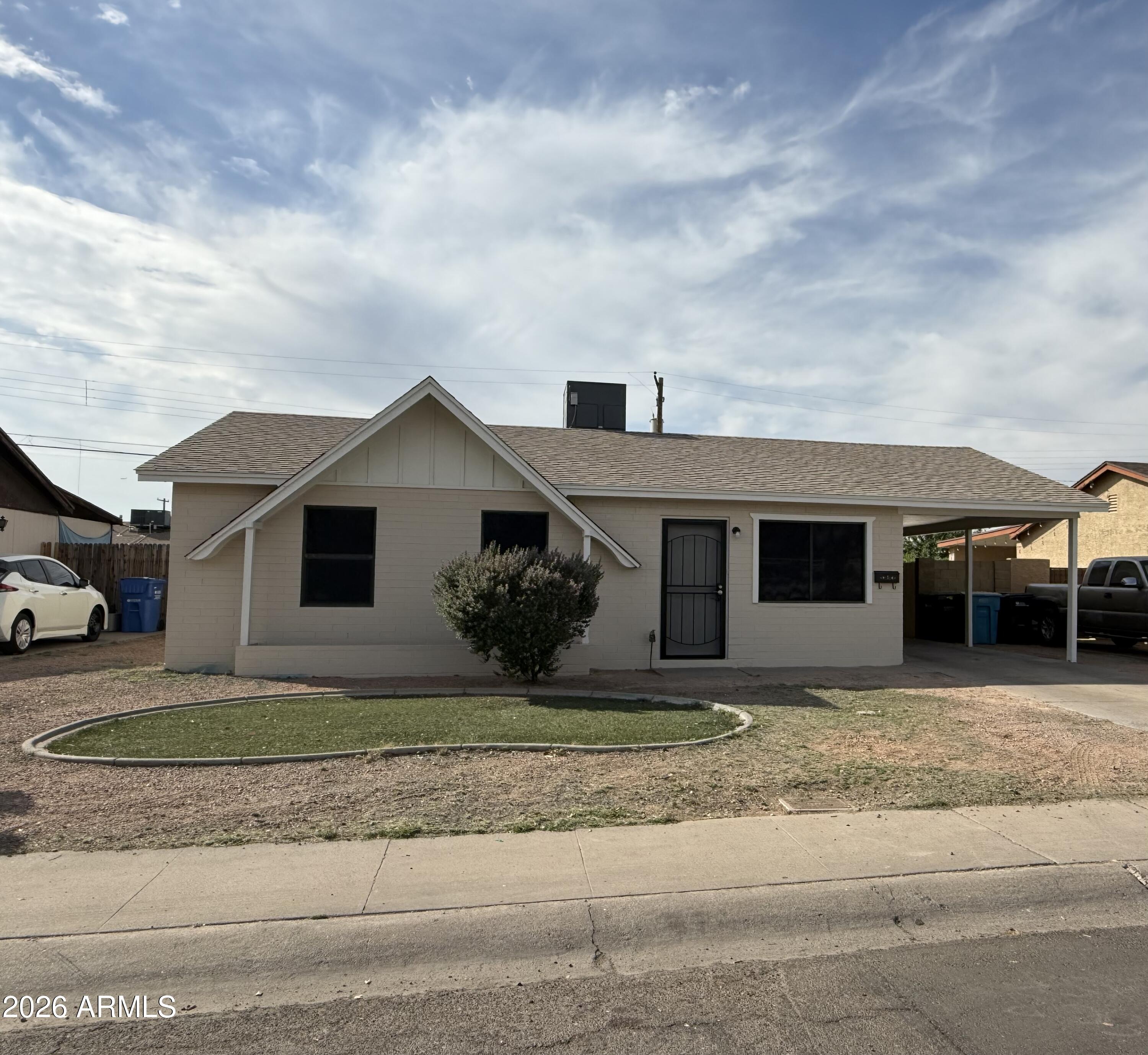 5807 West Flower Street Phoenix, AZ 85031 - Photo 1 of 11 a front view of a house with a yard