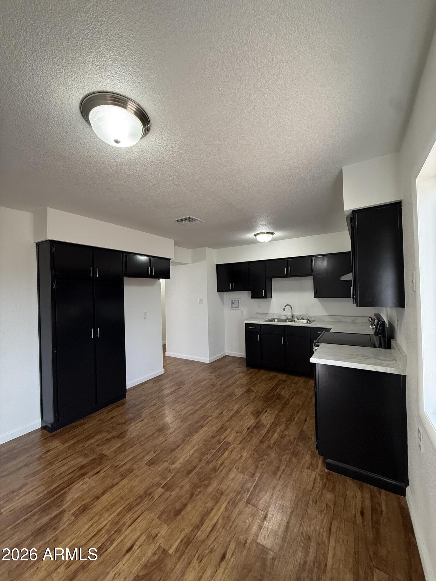 5807 West Flower Street Phoenix, AZ 85031 - Photo 5 of 11 a view of kitchen with sink and microwave