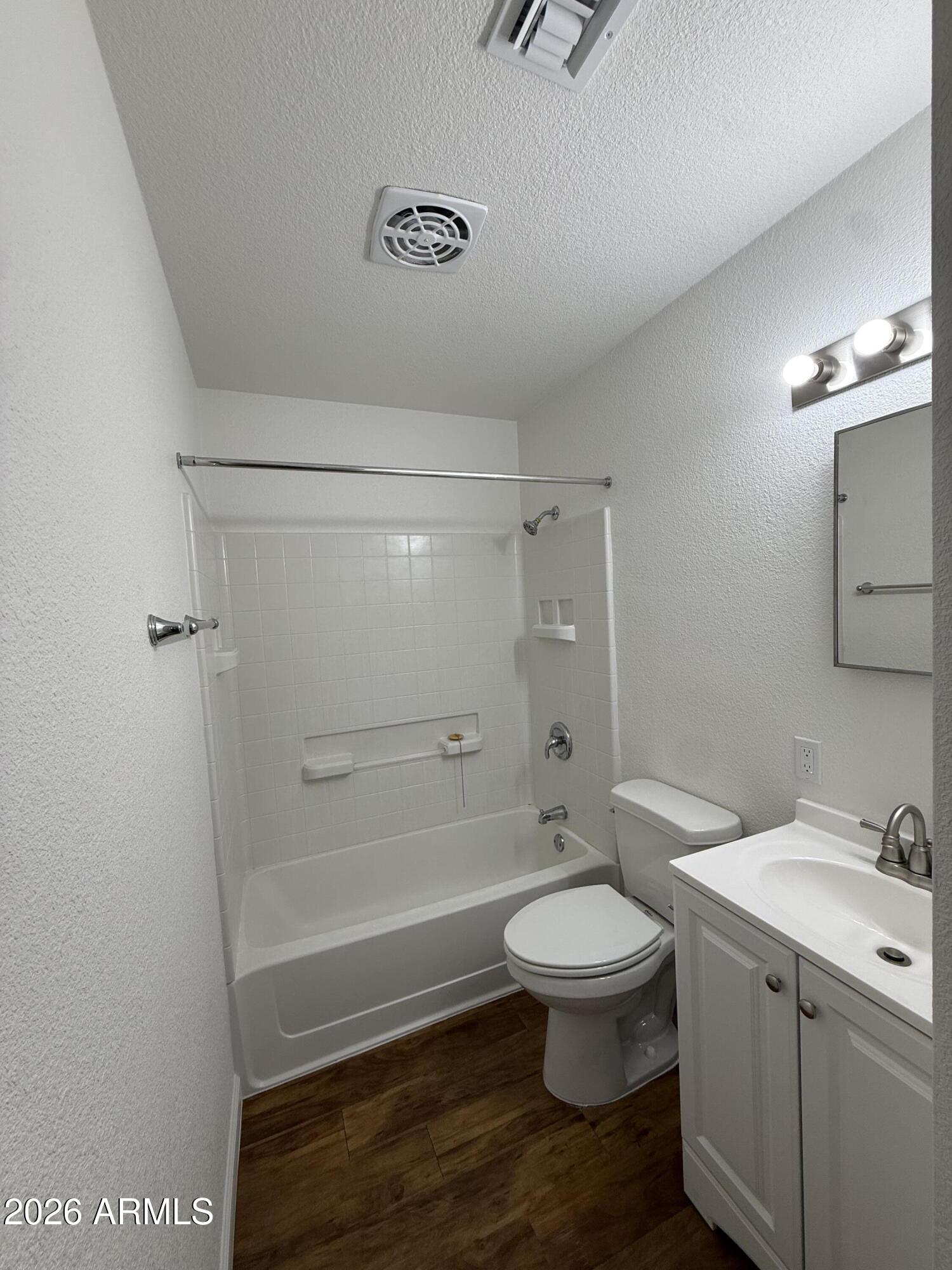 5807 West Flower Street Phoenix, AZ 85031 - Photo 8 of 11 a bathroom with a granite countertop toilet a sink and a shower