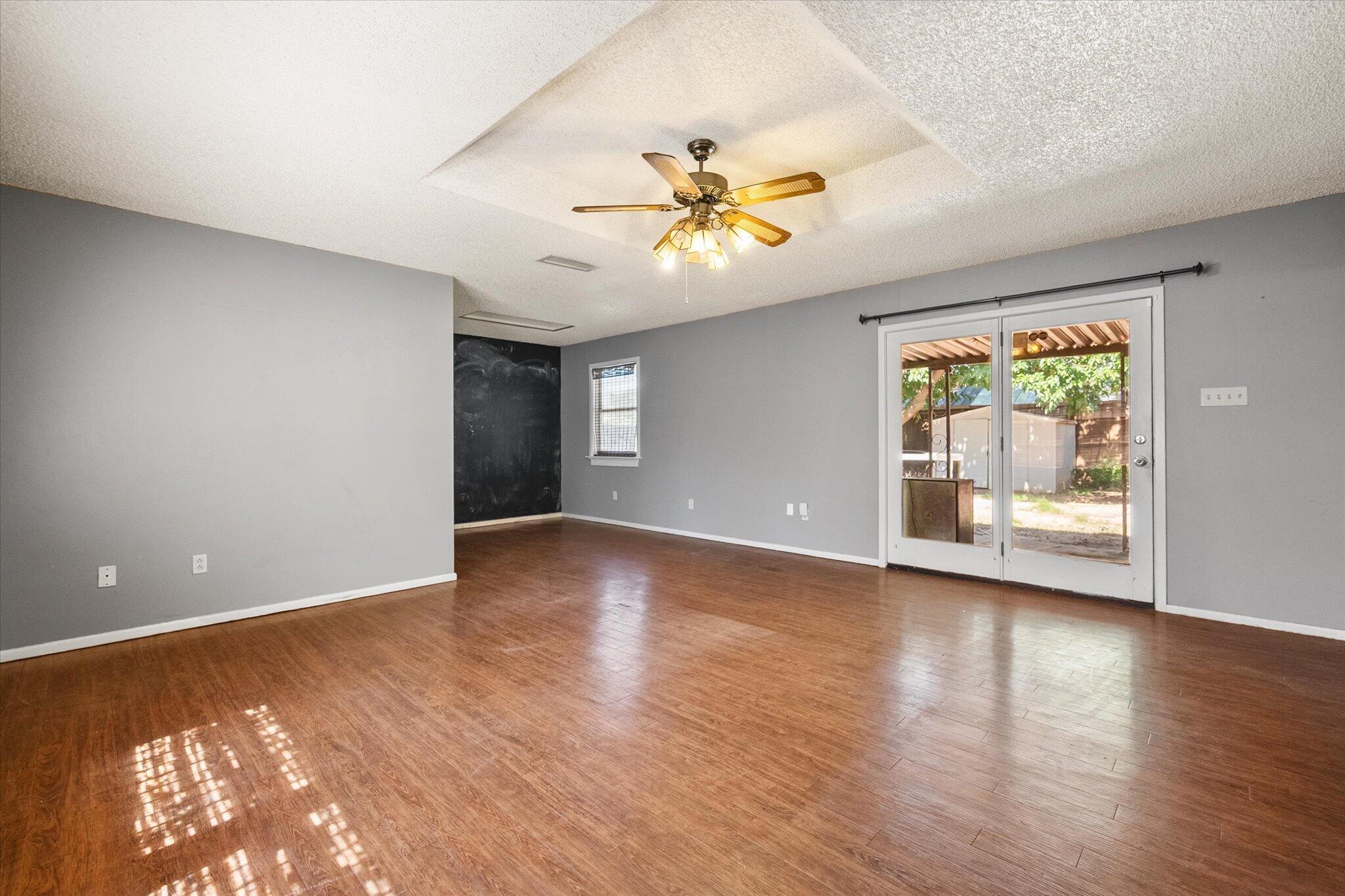 4604 27th Street Lubbock, TX 79410 - Photo 32 of 36 a view of an empty room with window and wooden floor